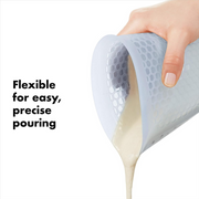 OXO Good Grips 2-Cup / 500ml Squeeze & Pour Measuring Cup with flexible silicone body and clear measurement markings.