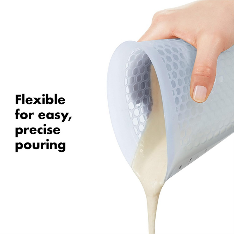 OXO Good Grips 2-Cup / 500ml Squeeze & Pour Measuring Cup with flexible silicone body and clear measurement markings.
