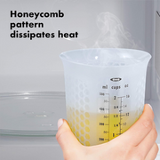 OXO Good Grips 2-Cup / 500ml Squeeze & Pour Measuring Cup with flexible silicone body and clear measurement markings.