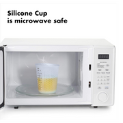 OXO Good Grips 2-Cup / 500ml Squeeze & Pour Measuring Cup with flexible silicone body and clear measurement markings.