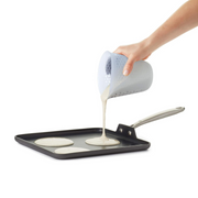 OXO Good Grips 2-Cup / 500ml Squeeze & Pour Measuring Cup with flexible silicone body and clear measurement markings.