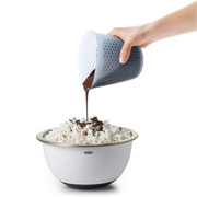 OXO Good Grips 2-Cup / 500ml Squeeze & Pour Measuring Cup with flexible silicone body and clear measurement markings.