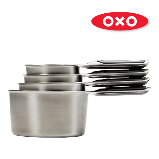 OXO Good Grips 4-Piece Stainless Steel Measuring Cup Set with etched markings, magnetic bases, and non-slip handles.