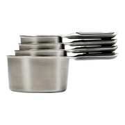 OXO Good Grips 4-Piece Stainless Steel Measuring Cup Set with etched markings, magnetic bases, and non-slip handles.