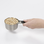 OXO Good Grips 4-Piece Stainless Steel Measuring Cup Set with etched markings, magnetic bases, and non-slip handles.