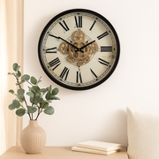 46cm round wall clock with compass design, black frame, natural wood accents, and real moving cogs