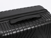 Close-up of a black textured suitcase with a handle on a light gray background – thumbnail