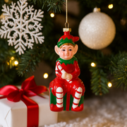 13.3cm Christmas tree ornament featuring a cheerful elf sitting on a festive gift box
