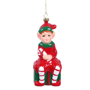 13.3cm Christmas tree ornament featuring a cheerful elf sitting on a festive gift box
