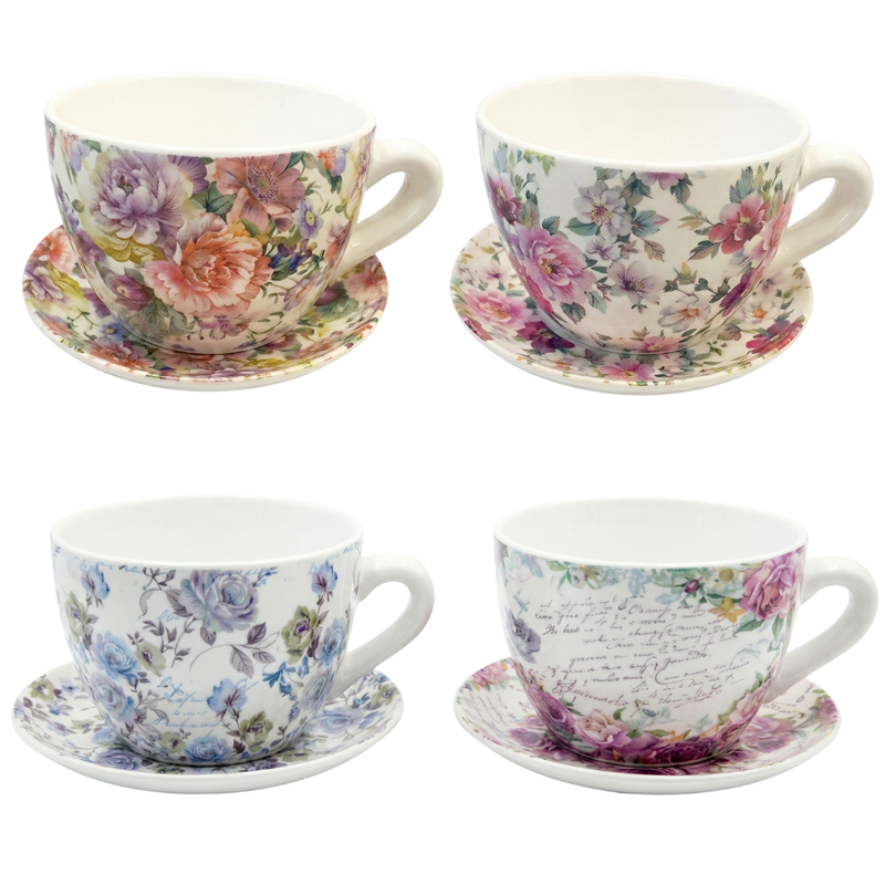 Set of four floral teacups and saucers on a white background