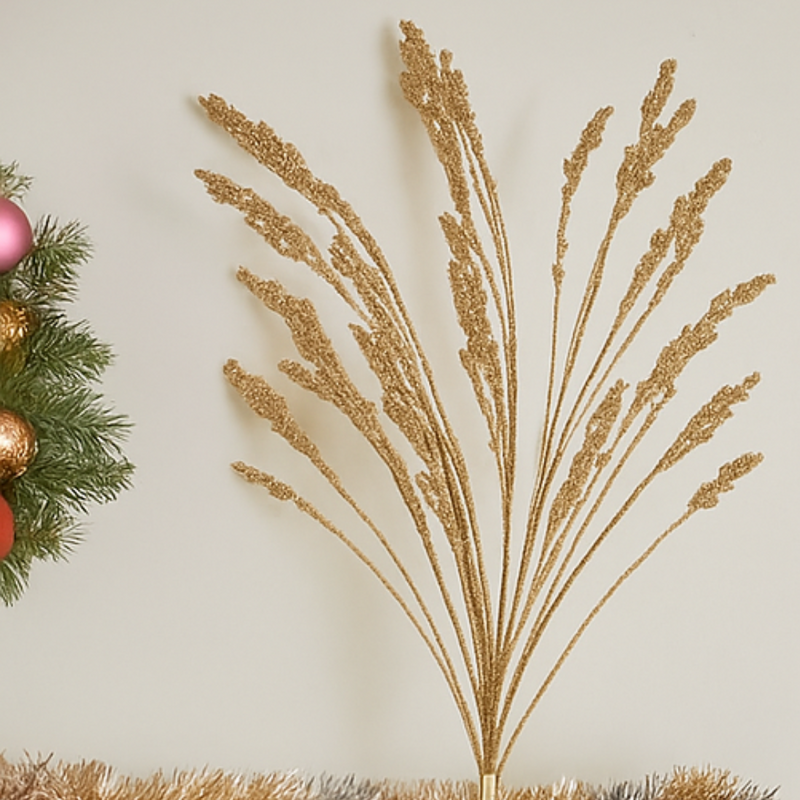 Decorative gold branch with festive ornaments on a light background