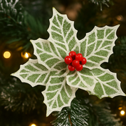 Decorative holly leaf with red berries on a blurred Christmas tree background