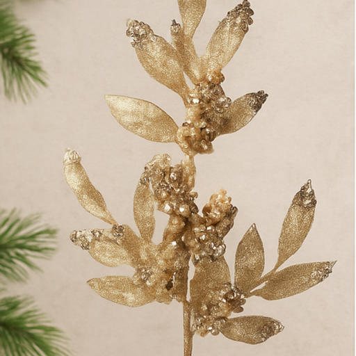Decorative gold leaf branch against a neutral background