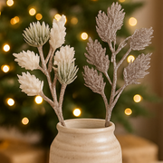 Decorative branches in a vase with a blurred festive background