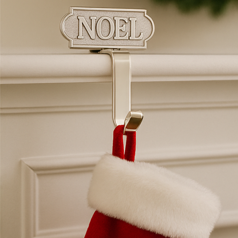 Red stocking with white fur trim hanging from a 'NOEL' sign on a beige wall.