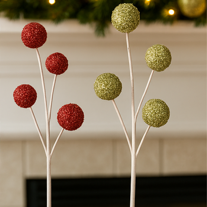 Decorative trees with red and green glittery spheres against a neutral background