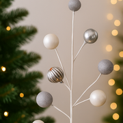 Decorative branch with spherical ornaments against a festive background