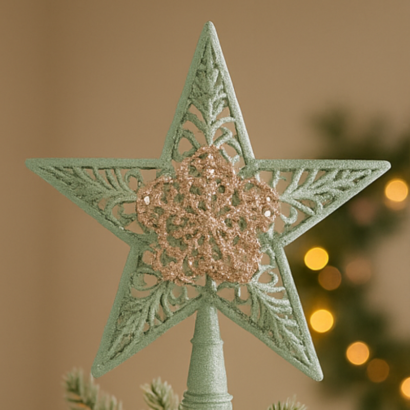 Decorative star ornament with a heart in the center on a blurred Christmas tree background.