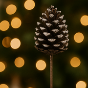 Pine cone with snow against a blurred light background