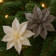 Two glittery poinsettia flowers on a Christmas tree.