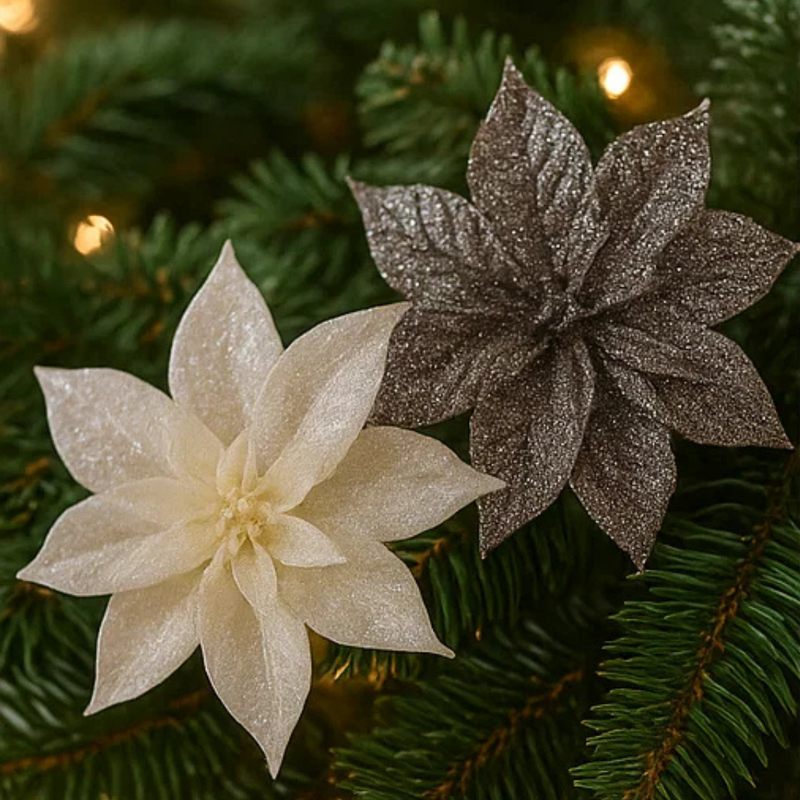 Two glittery poinsettia flowers on a Christmas tree.
