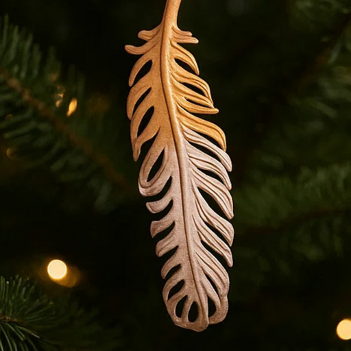 Decorative feather ornament on a Christmas tree with blurred lights in the background
