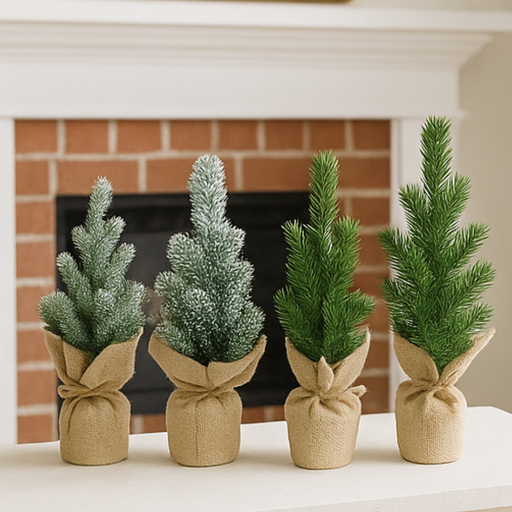 Four small artificial Christmas trees wrapped in burlap in front of a fireplace.