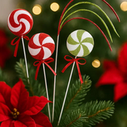 Decorative lollipops on sticks with red ribbons against a Christmas-themed background. – thumbnail