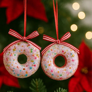Two donut-shaped Christmas ornaments with red ribbons on a festive background.