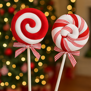 Two candy-themed lollipops with a blurred Christmas tree in the background – thumbnail