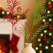 Decorative red and green plants in a vase with a festive background
