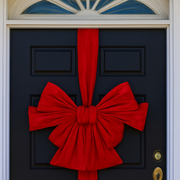 Black door with a large red bow decoration – thumbnail