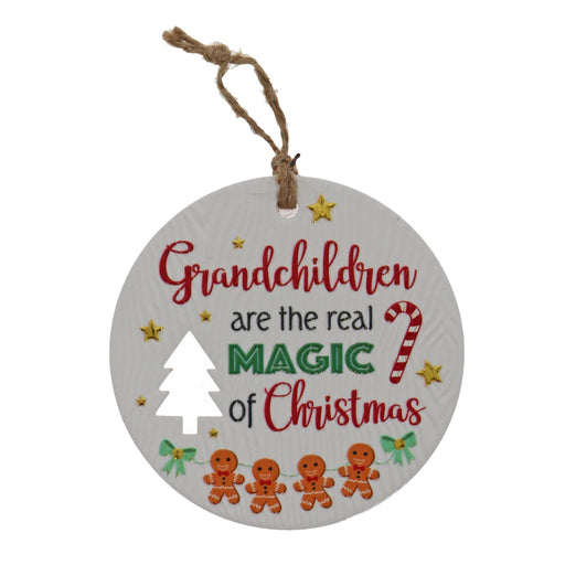 Grandchildren holiday message plaque near photos