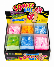 Colourful cube-shaped squeeze balls with marble designs, individually boxed and arranged in a product display. Squishy toys – thumbnail