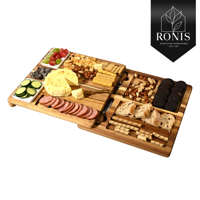 Wooden charcuterie board with assorted foods on a white background, featuring the Ronis brand.