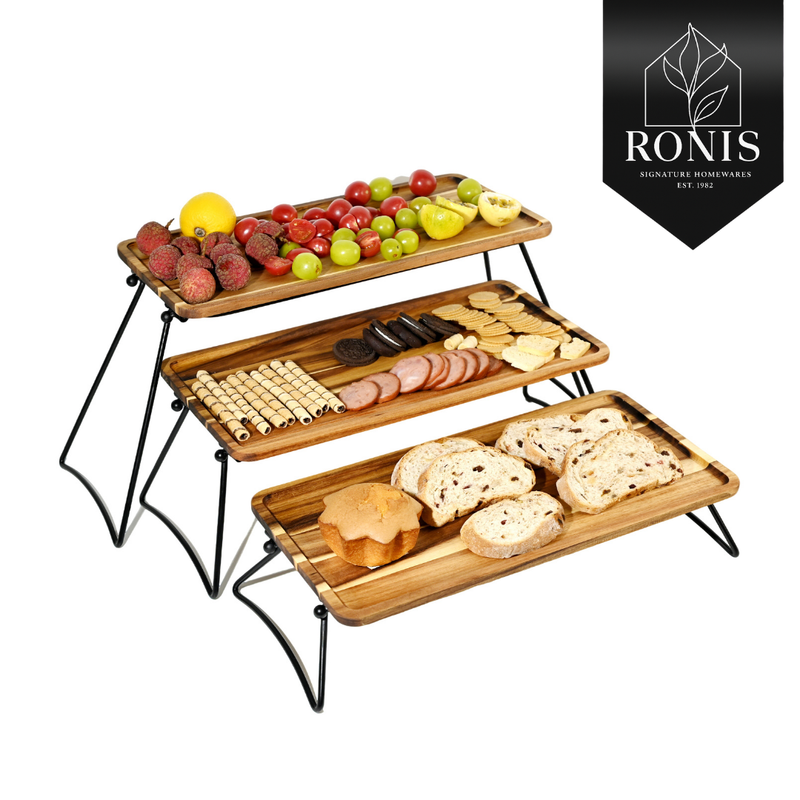 Three-tiered wooden food display with fruits, meats, and bread on a white background, featuring the Ronis Signature Homewares