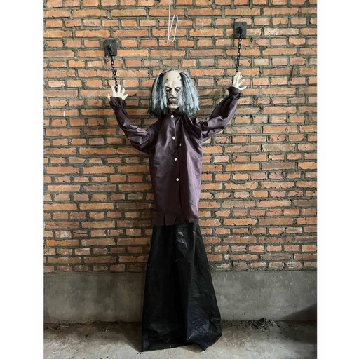 Child-sized animatronic prop of a hanging cuffed man with grey hair, red glowing eyes, and shackled arms, suspended as a Halloween decoration.

