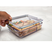 food container with compartments filled with food, being held by a hand 