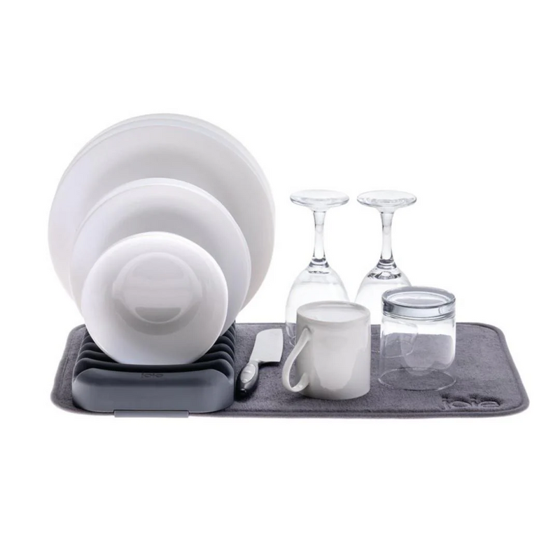 Dish drying rack with white dishes and glasses 