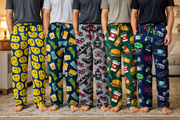 Five people wearing colorful patterned pajama pants on a carpeted floor. – thumbnail
