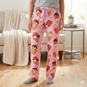 Person wearing pink lounge pants with ice cream pattern in a living room. – thumbnail